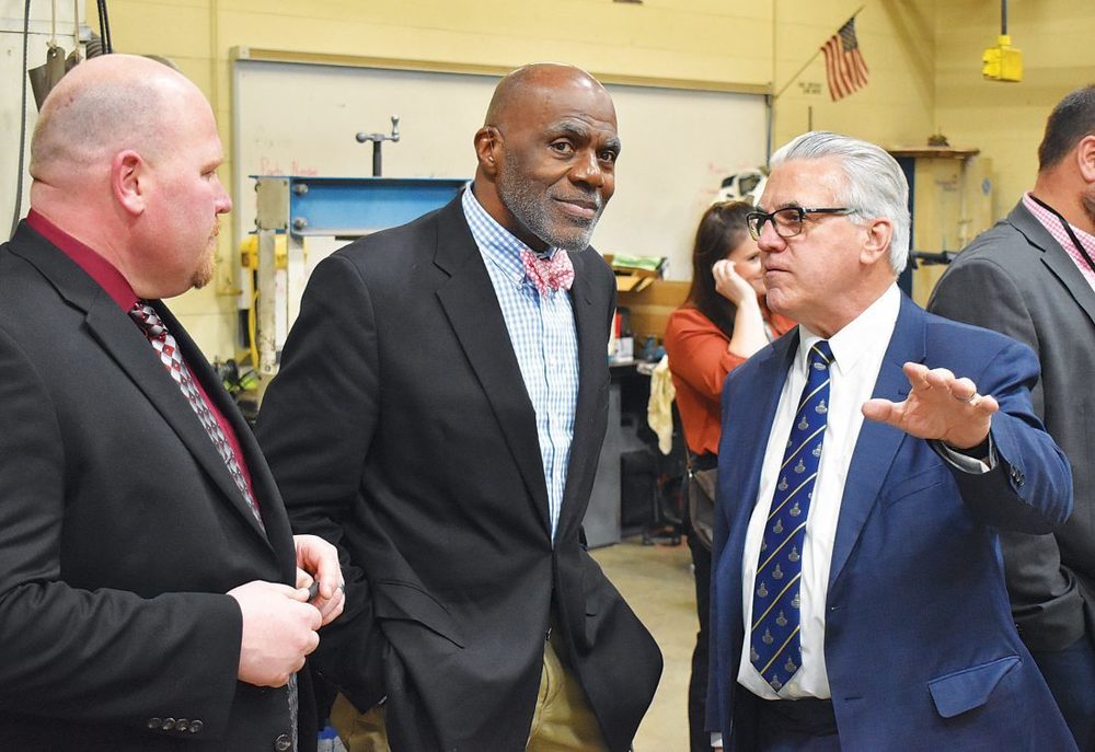Former Minnesota Supreme Court Justice Alan Page, center, talks with Fairmont Area Schools Superintendent Joe Brown, right, and high school principal Jake Tietje in the school’s automotive academy Thursday. Page and Minneapolis Federal Reserve chief Neel Kashkari visited the school to discuss their proposed state constitutional amendment aimed at improving the quality of public education in Minnesota.