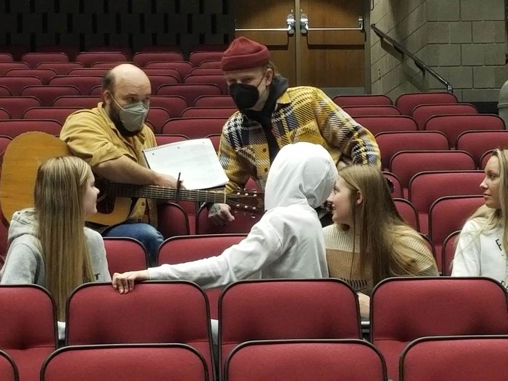 Musician working with student in the performing arts center 